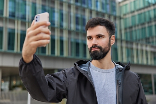 Handsome,Bearded,Man,Takes,Selfie,Via,Smartphone,Wears,Black,Jacket